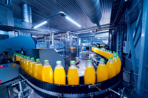 Beverage factory interior. Conveyor with bottles for juice or water. Equipments Beverage factory interior. Conveyor with bottles for juice or water. Modern equipments