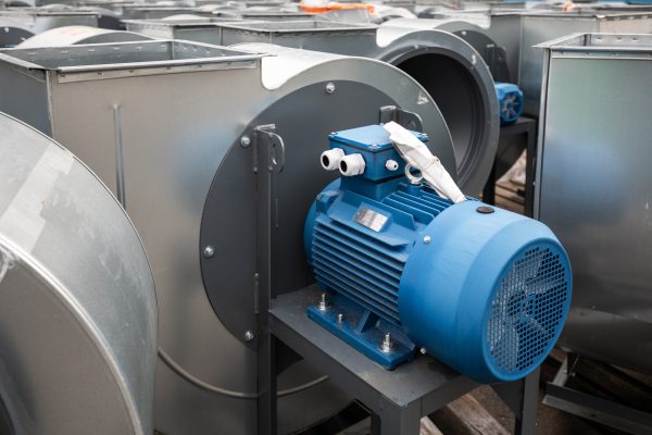 Batch of industrial exhaust snail fans with installed electric motors for air ventilation in a factory open-air warehouse storage area awaiting transportation. Batch of industrial exhaust snail fans with installed electric motors for air ventilation in a factory open-air warehouse storage area awaiting transportation.